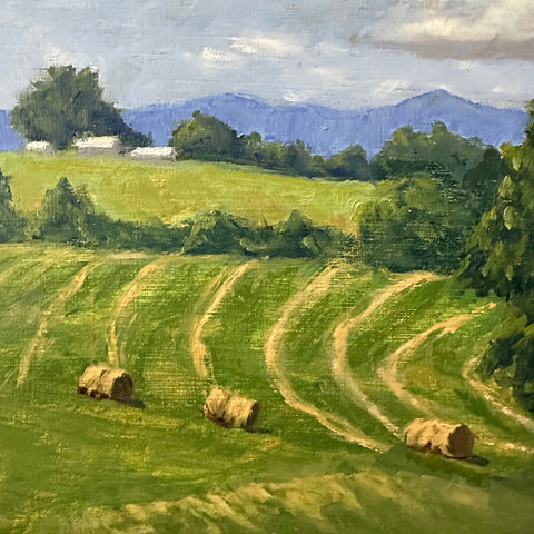 Detail of Landscape painting of a green field with haybales, a farm in the background and blue mountains in the distance against a blue sky by Kathy Chumley - Cottage Curator - Sperryville VA Art Gallery