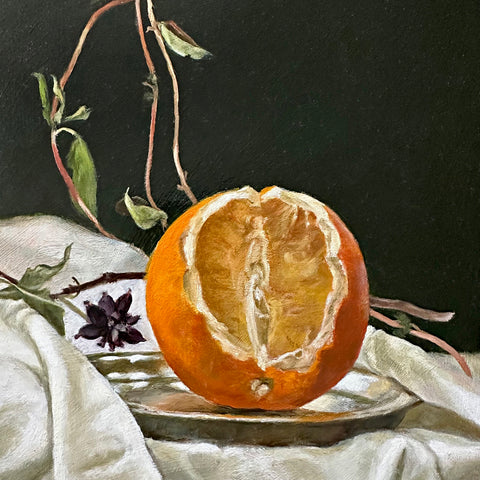 Detail of a still life oil painting of a cut orange on a silver plate against a dark green background with vines on a white tablecloth by Davette Leonard at Cottage Curator - Sperryville VA Art Gallery