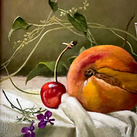 Detail of a still life painting with a cut peach, cherries and stems of lobelia arranged on a white tablecloth against an olive green background by Davette Leonard at Cottage Curator - Sperryville VA Art Gallery