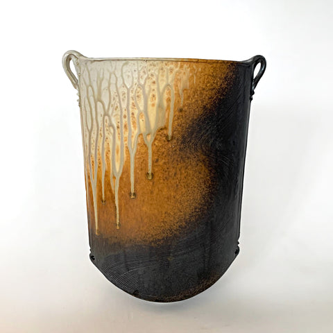 Oval shaped ceramic vessel with two small handles at the top on either side and ochre, white and charcoal colored wood ash glaze by Richard Aerni at Cottage Curator - Sperryville VA Art Gallery