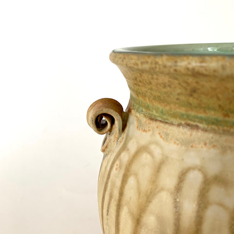 Detail of stoneware vessel with celadon green interior and rust cream glaze on exterior with two small handles by Richard Aerni - Cottage Curator - Sperryville VA Art Gallery