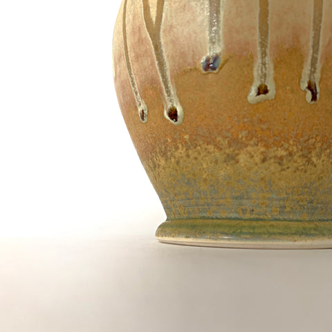 Detail of stoneware vessel with celadon green interior and rust cream glaze on exterior with two small handles by Richard Aerni - Cottage Curator - Sperryville VA Art Gallery