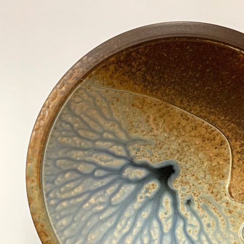 Detail of Stoneware wall platter with brown and blue/gray glazing and raised spiral design by Richard Aerni at Cottage Curator - Sperryville VA Art Gallery