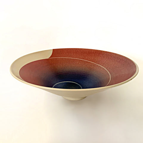 Tapered porcelain bowl with ivory exterior and spiral center design glazed in pink/orange and blue/purple by Wayne Bates at Cottage Curator - Sperryville VA Art Gallery