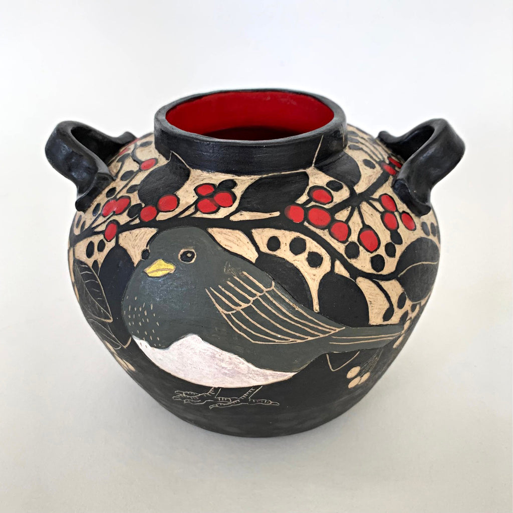 Black and white stoneware vessel with sgraffito carved images of Juncos and berries, with red and yellow painted details and red interior by Carolyn Blazeck at Cottage Curator - Sperryville VA
