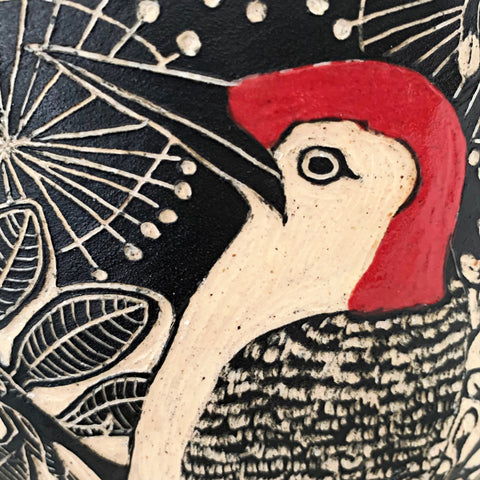 Detail of woodpecker on black and white vessel with pine needle edge in black terra sigillata and sgraffito with woodpeckers by Carolyn Blazeck at Cottage Curator - Sperryville VA Art Gallery