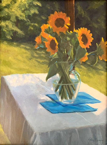 Still life with vase of sunflowers on a table set outdoors with white tablecloth and blue linens by Kathy Chumley at Cottage Curator - Sperryville VA Art Gallery
