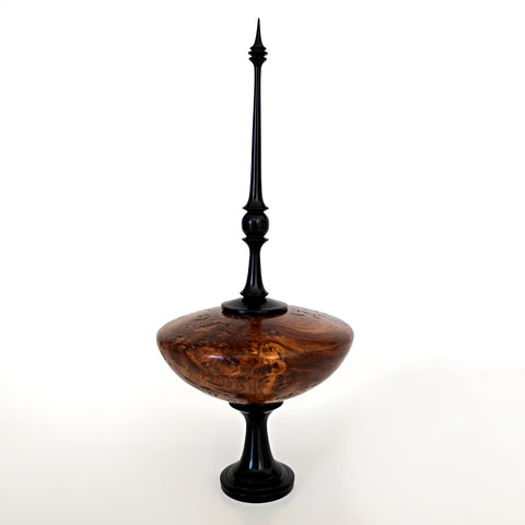 Turned wood vessel with round grained wood body and tall black finial top with black pedestal bottom by L. Michael Fraser at Cottage Curator - Sperryville VA Art Gallery