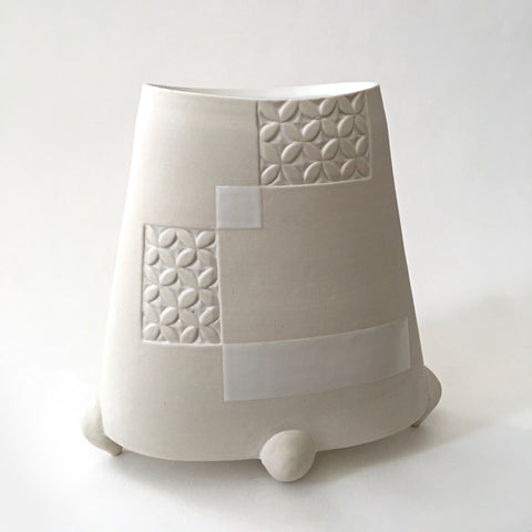 Alternate view of white tapered porcelain vessel with rectangular patches of carved patterns and three feet by Yoshi Fujii at Cottage Curator - Sperryville VA Art Gallery