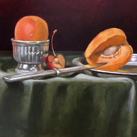 Detail of long, narrow still life with green tablecloth against a dark red background and red and yellow apricots by Davette Leonard at Cottage Curator - Sperryville VA Art Gallery