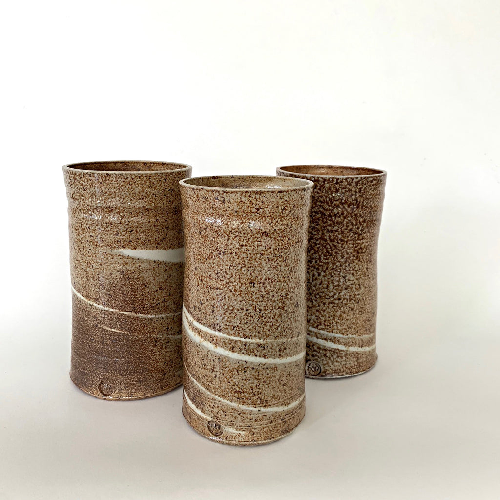 Set of three cylindrical vases in brown textured finish with white swirls by Virginia Rood Pates at Cottage Curator - Sperryville VA Art Gallery