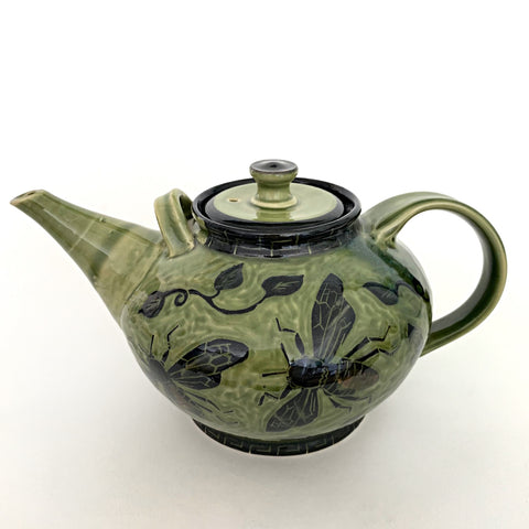 Side view of stoneware teapot with lid glazed in green and black with bees by Neal Reed - Cottage Curator -Sperryville VA Art Gallery
